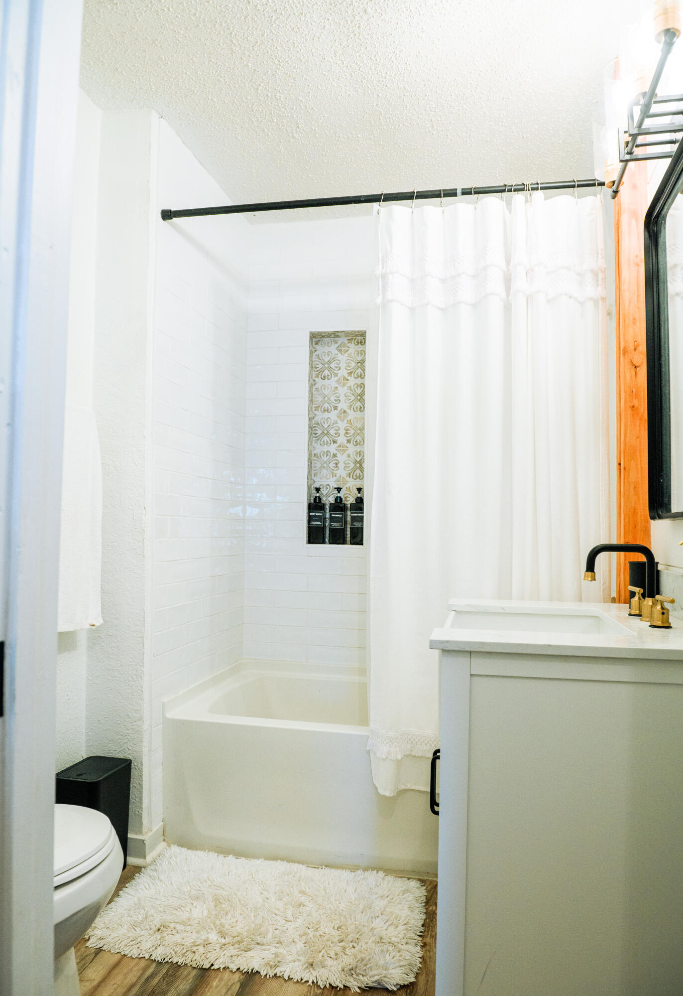 2436 24th Street Lubbock, TX 79411 - Photo 15 of 29 a bathroom with a sink and a bathtub