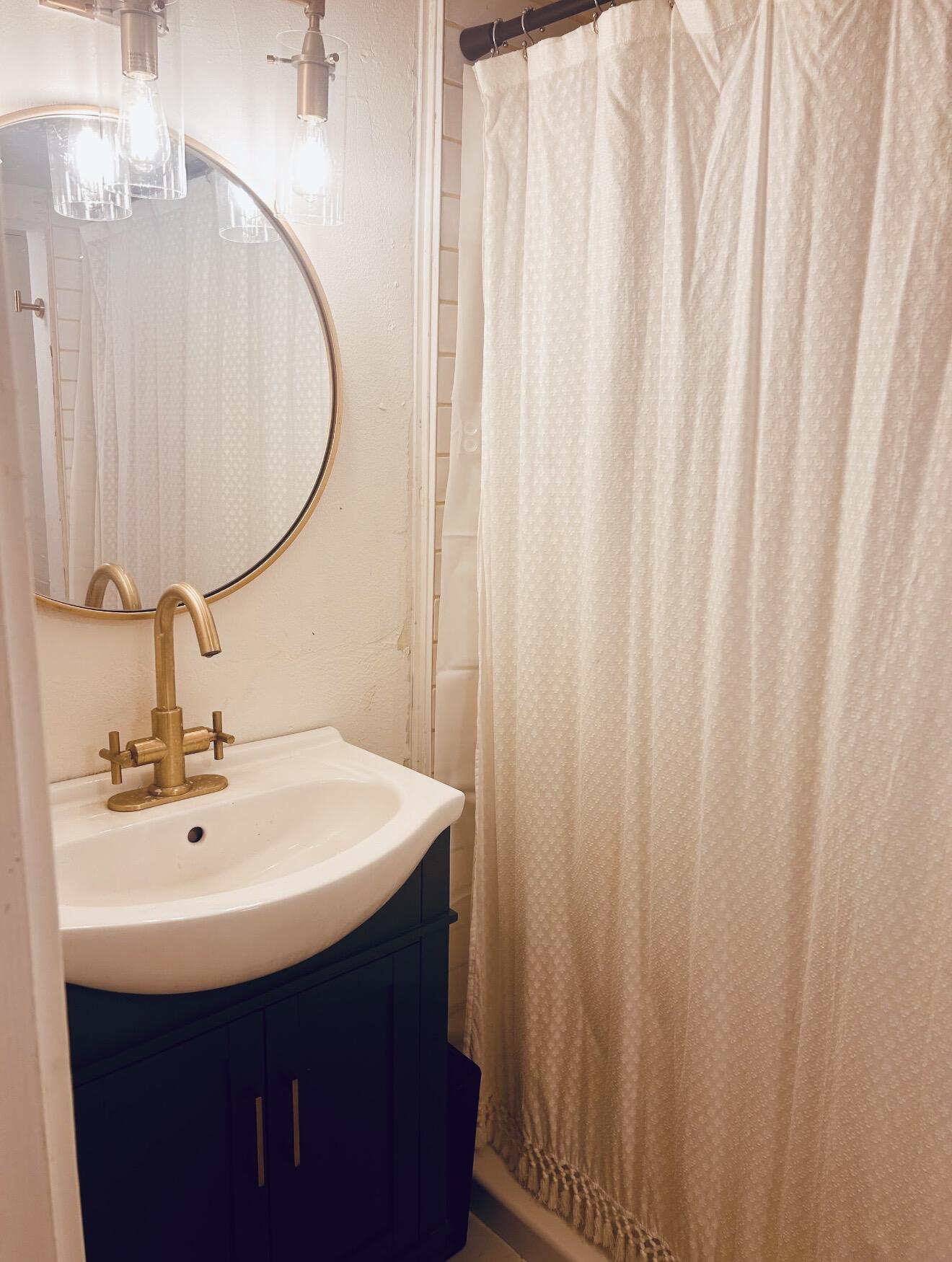 2436 24th Street Lubbock, TX 79411 - Photo 29 of 29 a bathroom with a sink and a mirror