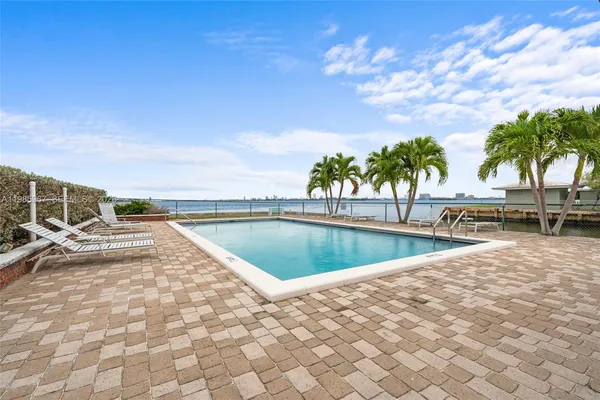 a view of swimming pool with chairs