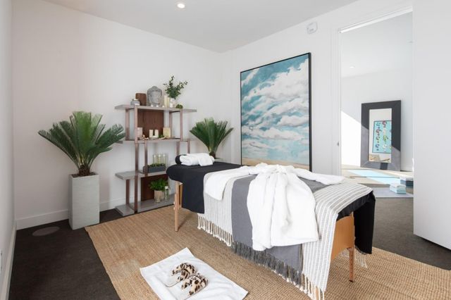 a bed sitting in a spacious bedroom next to a window