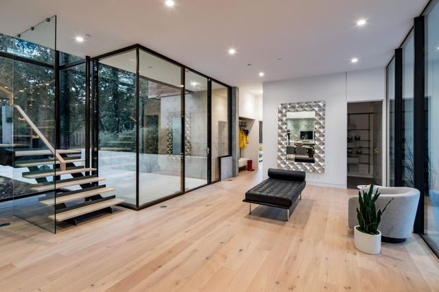 a living room with furniture gym equipment and a wooden floor