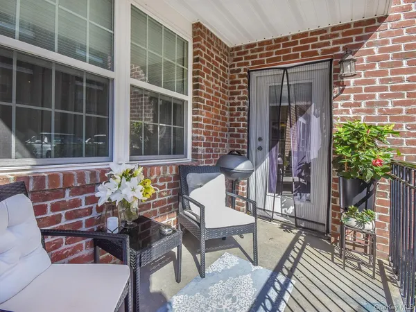 a front view of a house with outdoor seating