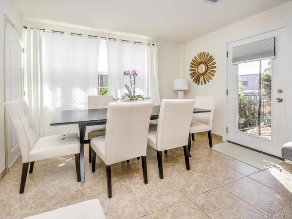a view of a dining room with furniture and a large window
