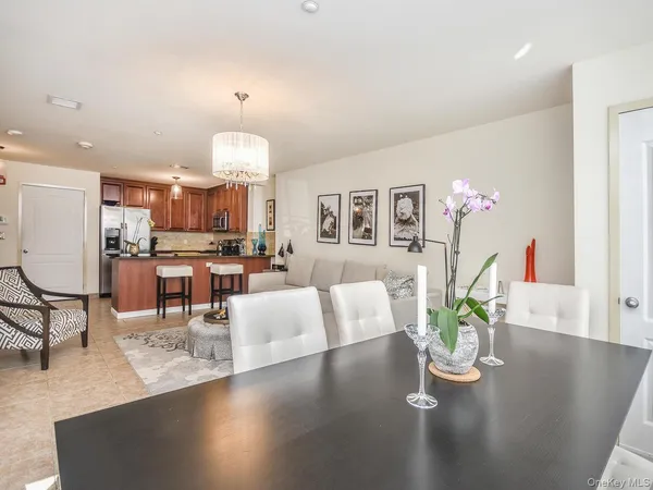 a living room with dining table furniture and a chandelier