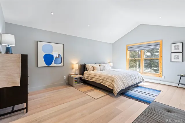 a bedroom with a bed and a large window