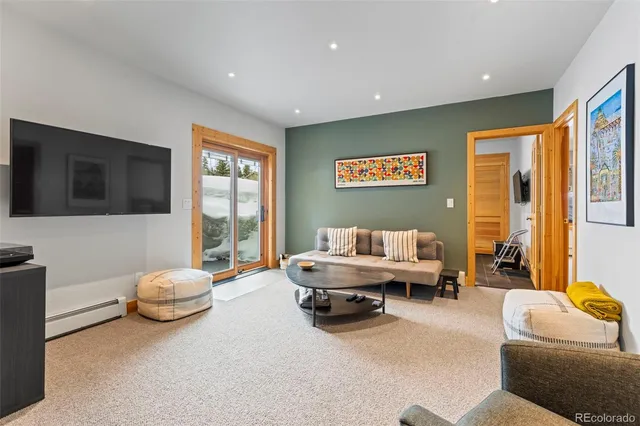 a kitchen with a stove and a wooden floor