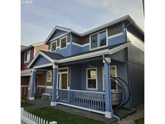 a view of a house with iron fence