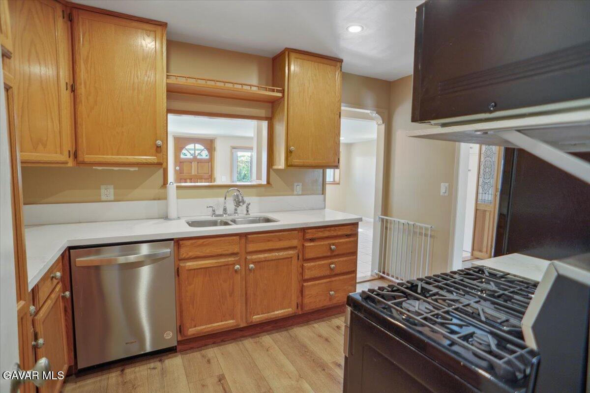42652 55th Street West Lancaster, CA 93536 - Photo 12 of 28 a kitchen with a stove and a sink