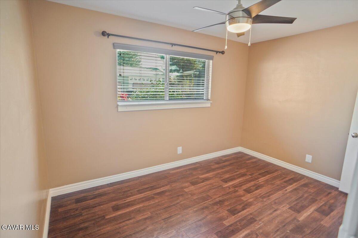 42652 55th Street West Lancaster, CA 93536 - Photo 17 of 28 a view of an empty room with wooden floor and a window