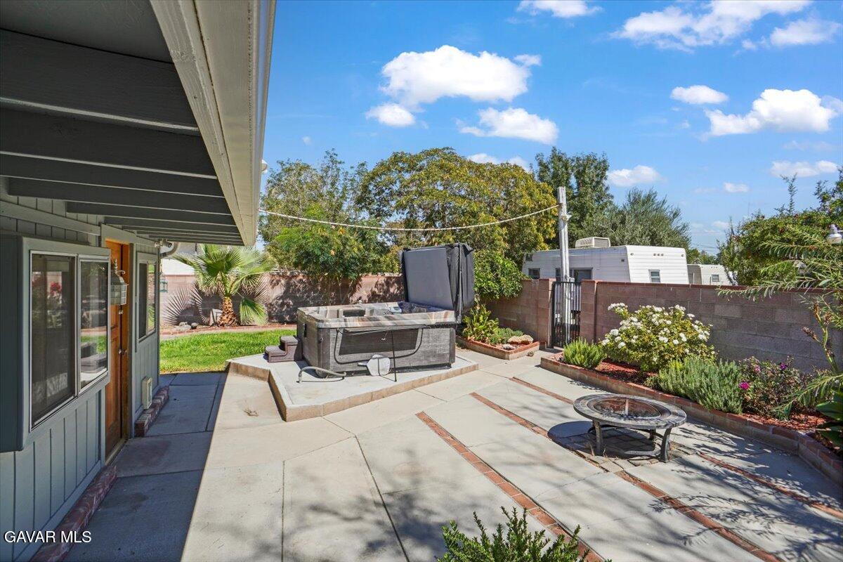 42652 55th Street West Lancaster, CA 93536 - Photo 19 of 28 a view of a patio with a table and chairs and potted plants