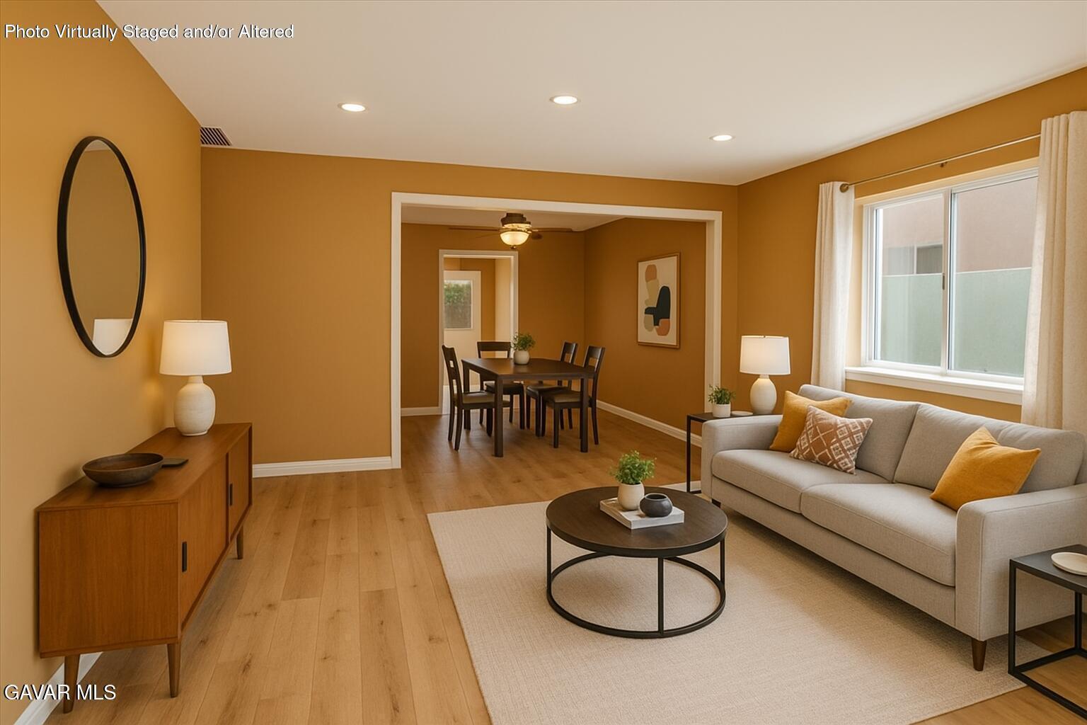 42652 55th Street West Lancaster, CA 93536 - Photo 2 of 28 a living room with furniture a rug and a floor to ceiling window