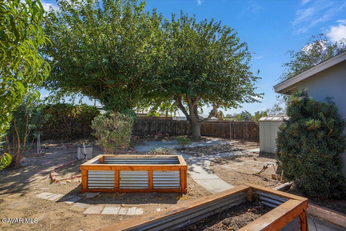 42652 55th Street West Lancaster, CA 93536 - Photo 26 of 28 a backyard of a house with yard and outdoor seating