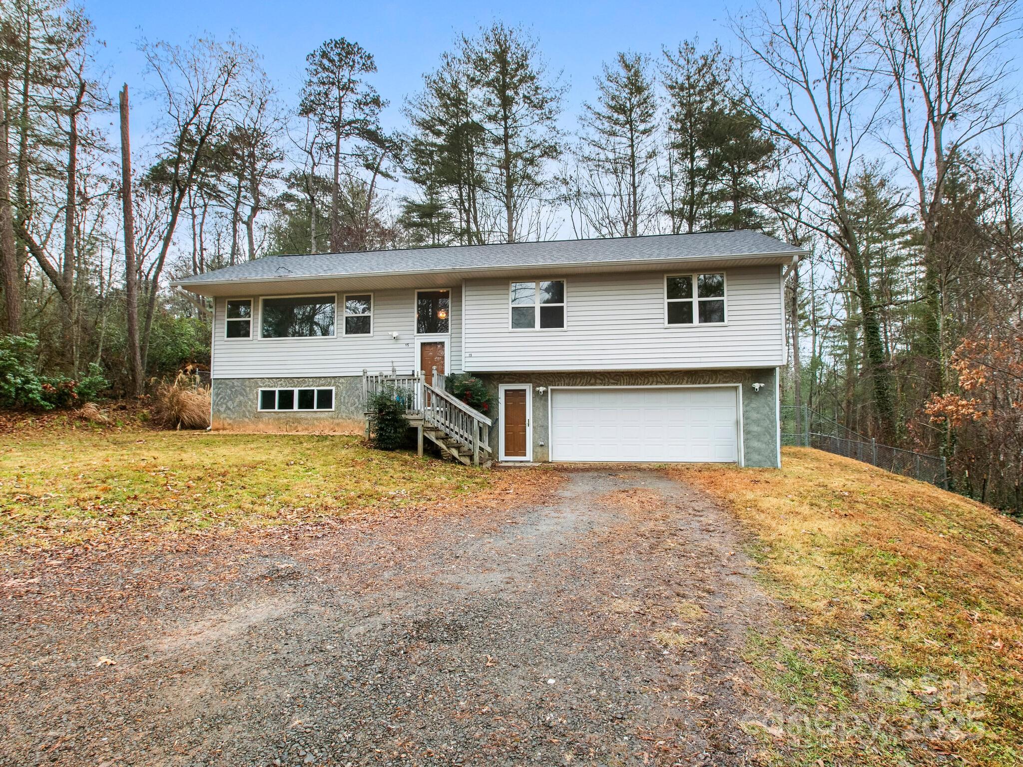 15 Gunflint Trail Fletcher, NC 28732 - Photo 2 of 25 a front view of a house with a yard and garage