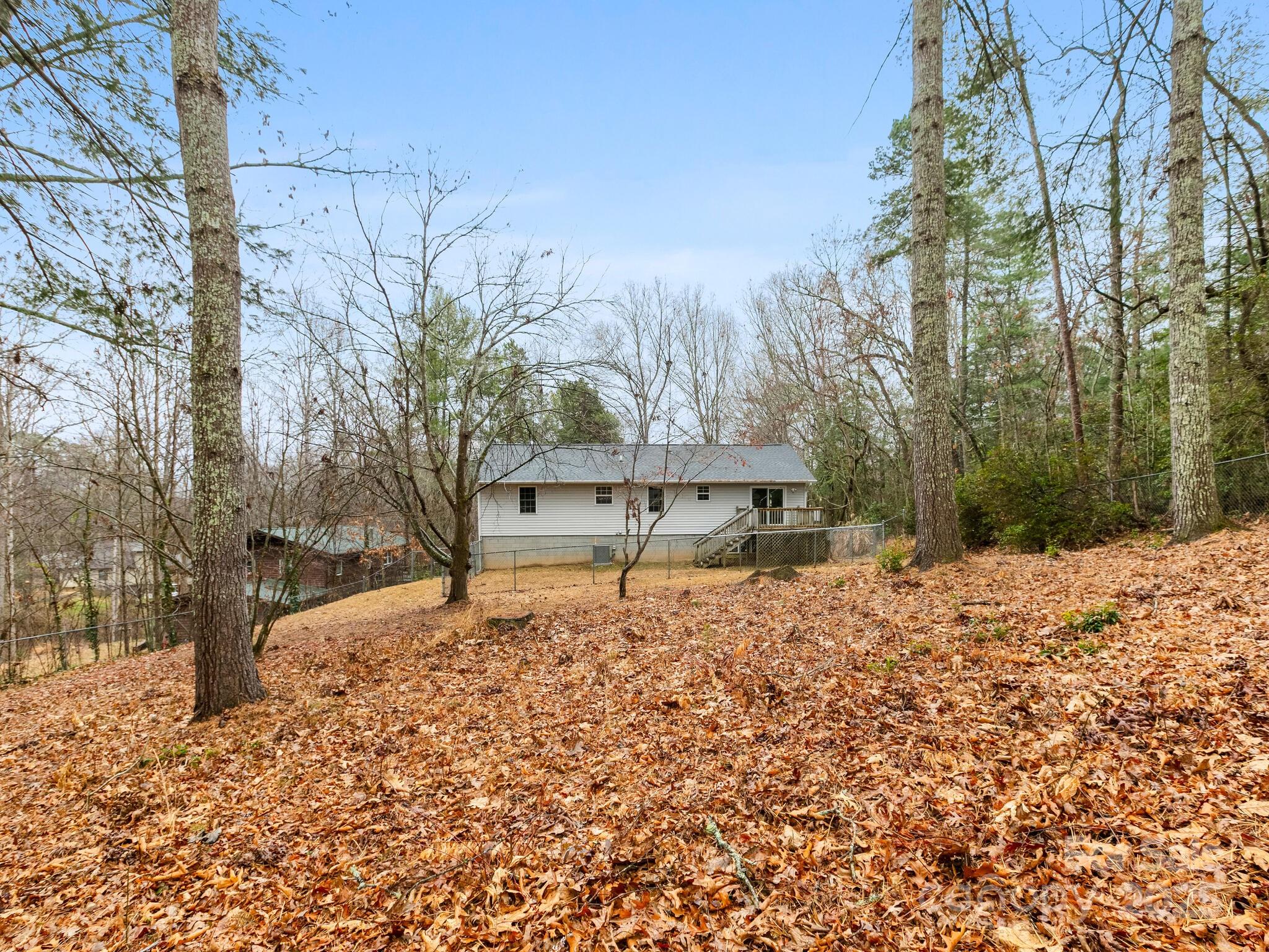 15 Gunflint Trail Fletcher, NC 28732 - Photo 25 of 25 a wooden bench sitting in the middle of a yard