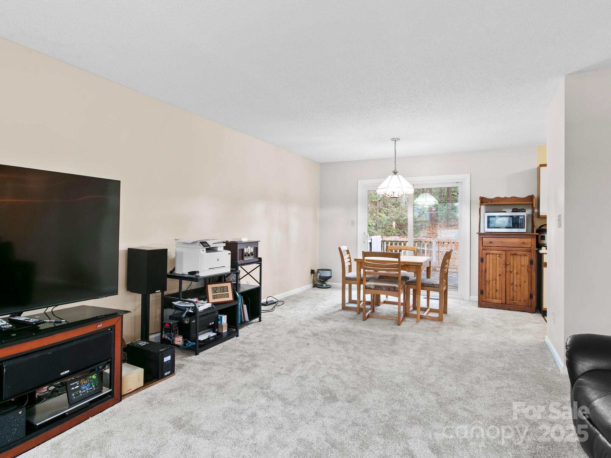 15 Gunflint Trail Fletcher, NC 28732 - Photo 6 of 25 a living room with furniture and a flat screen tv