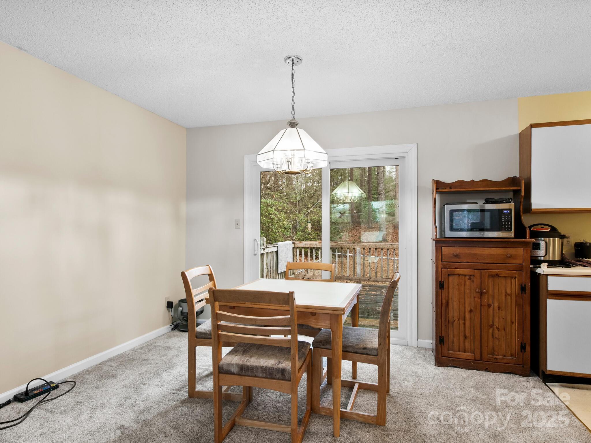 15 Gunflint Trail Fletcher, NC 28732 - Photo 7 of 25 a dining room with furniture a chandelier and wooden floor