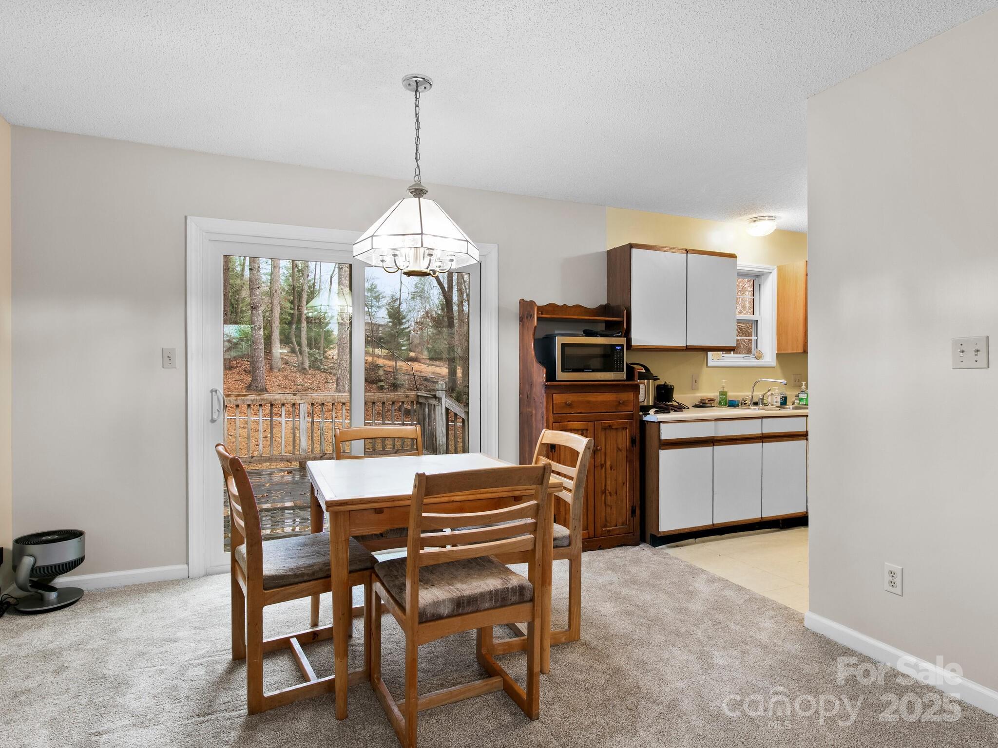 15 Gunflint Trail Fletcher, NC 28732 - Photo 8 of 25 a kitchen with a dining table chairs stainless steel appliances and cabinets