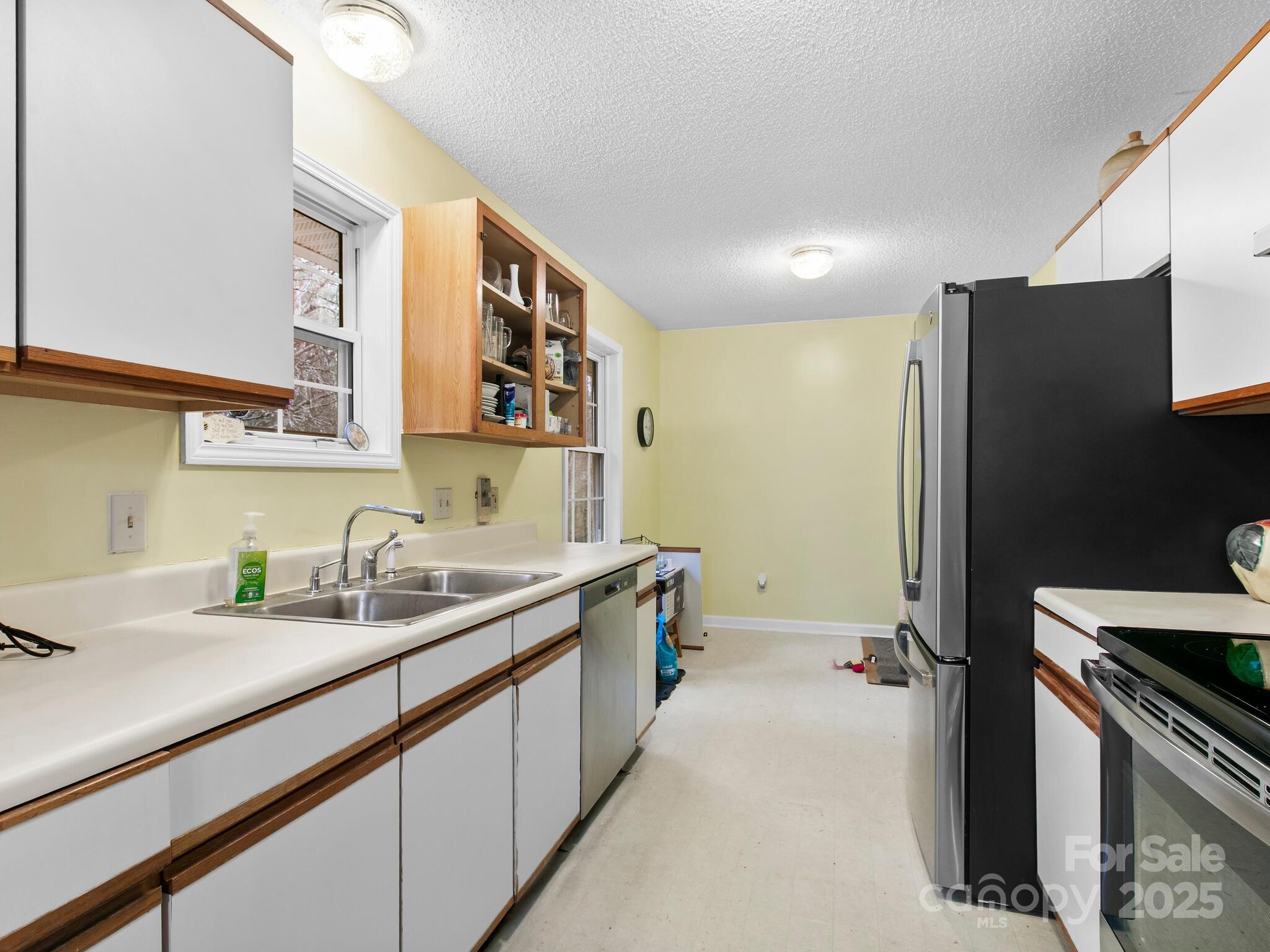 15 Gunflint Trail Fletcher, NC 28732 - Photo 10 of 25 a kitchen with a sink and a refrigerator