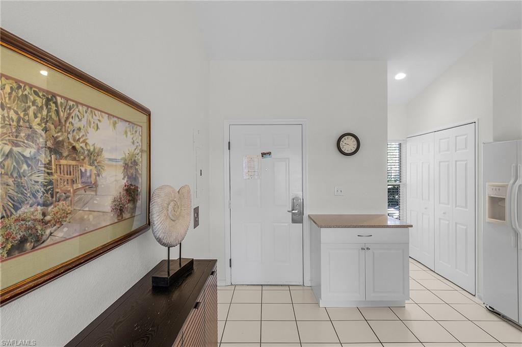 7870 Mahogany Run Lane, Unit 1724 Naples, FL 34113 - Photo 6 of 21 a bathroom with a sink and a mirror