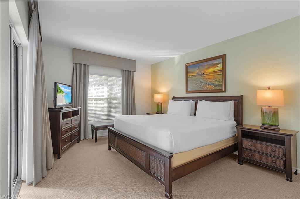 7870 Mahogany Run Lane, Unit 1724 Naples, FL 34113 - Photo 10 of 21 a bedroom with a bed and a window
