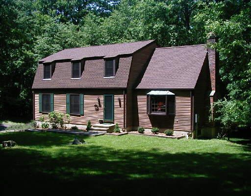 6 Pine Lake Road Ridgefield, CT 06877 - Photo 1 of 1 a front view of a house with a garden and plants