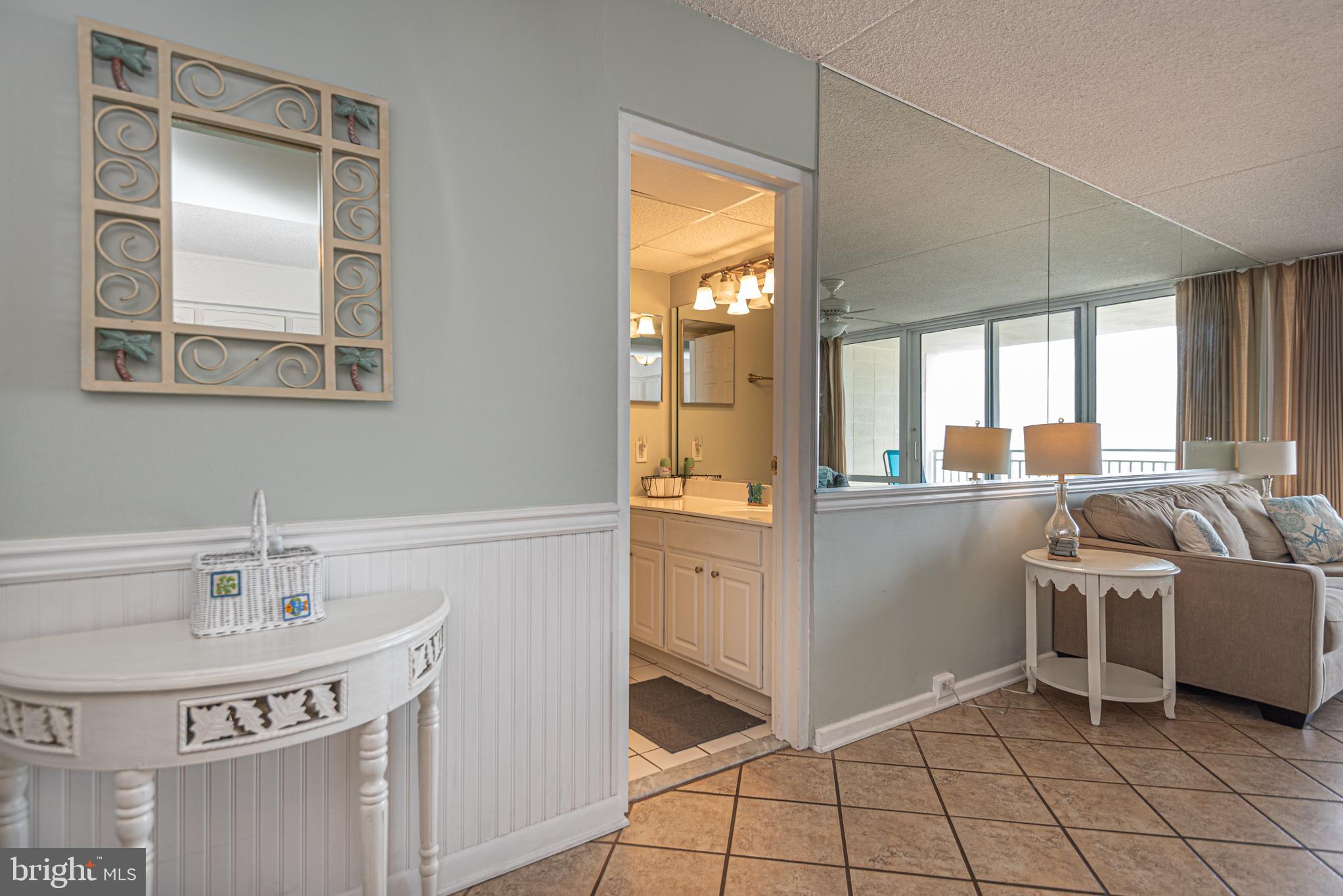 11700 Coastal Highway, Unit 1109 Ocean City, MD 21842 - Photo 12 of 50 a living room with a sink and furniture
