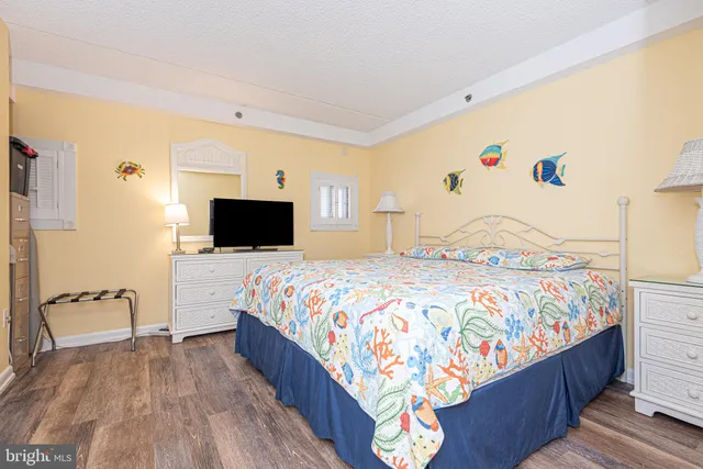 a bedroom with a bed and a television