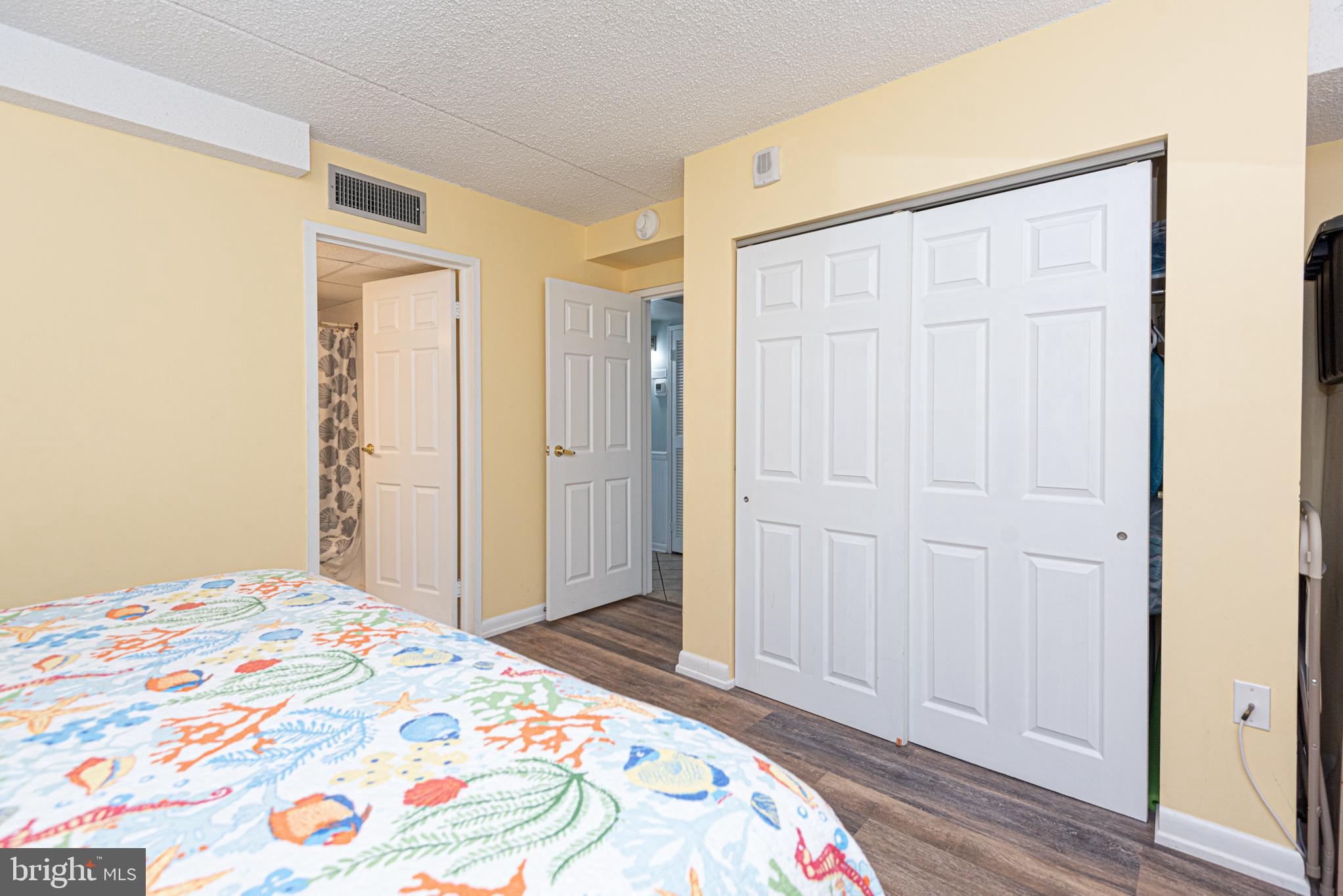 11700 Coastal Highway, Unit 1109 Ocean City, MD 21842 - Photo 15 of 50 a bedroom with a bed and a mirror