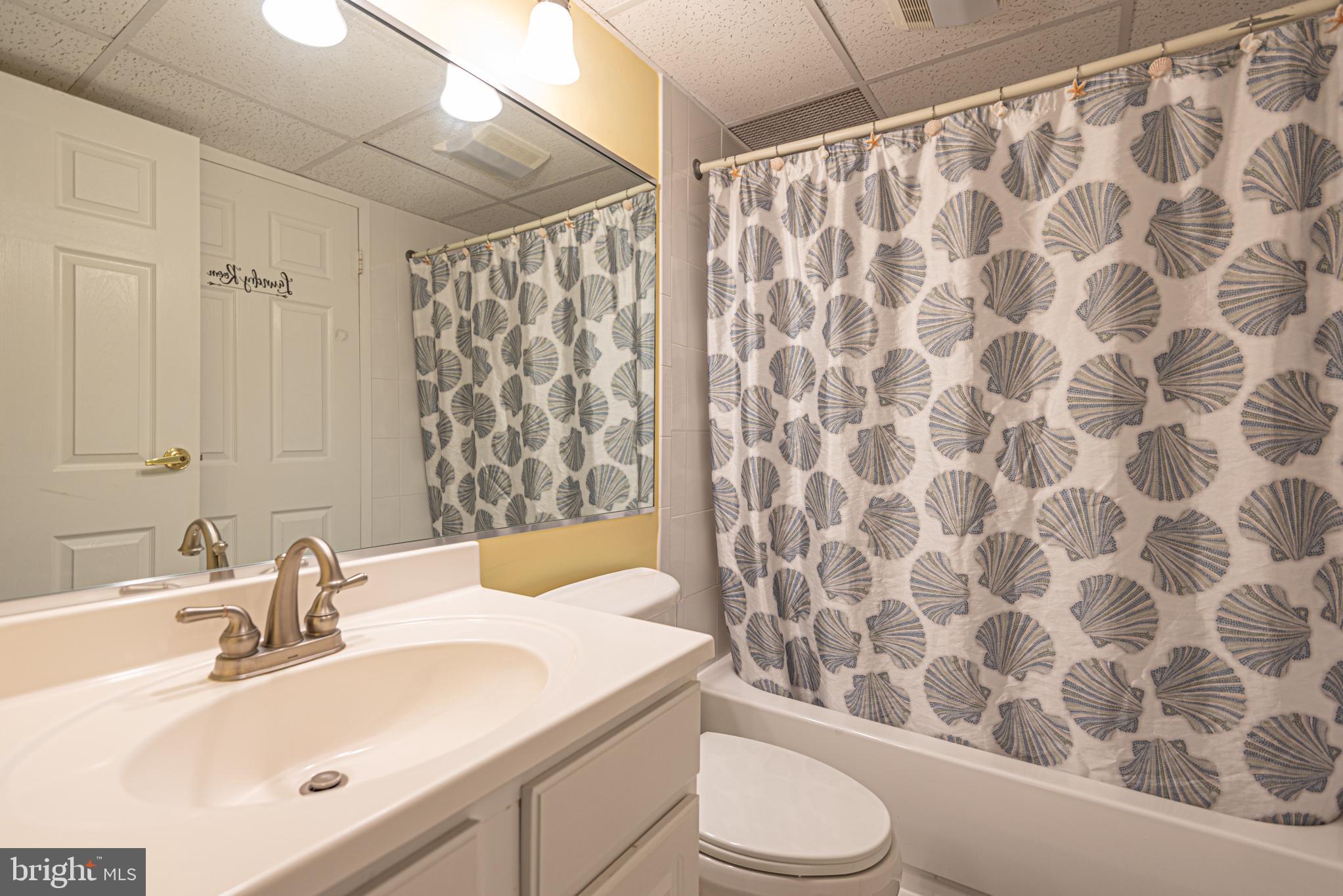 11700 Coastal Highway, Unit 1109 Ocean City, MD 21842 - Photo 17 of 50 a bathroom with a sink and a mirror