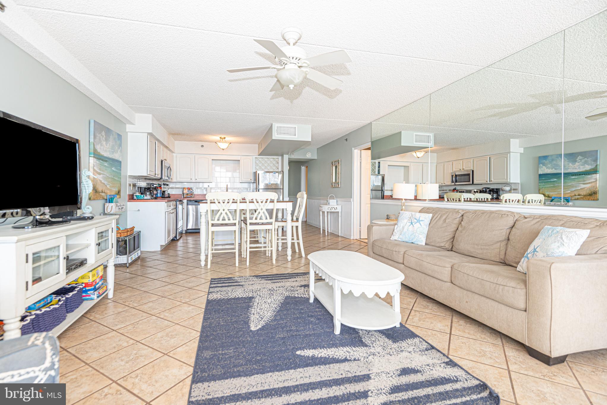 11700 Coastal Highway, Unit 1109 Ocean City, MD 21842 - Photo 20 of 50 a living room with furniture and a flat screen tv