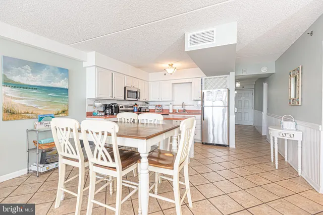 a view of a dining room with furniture and a chandelier