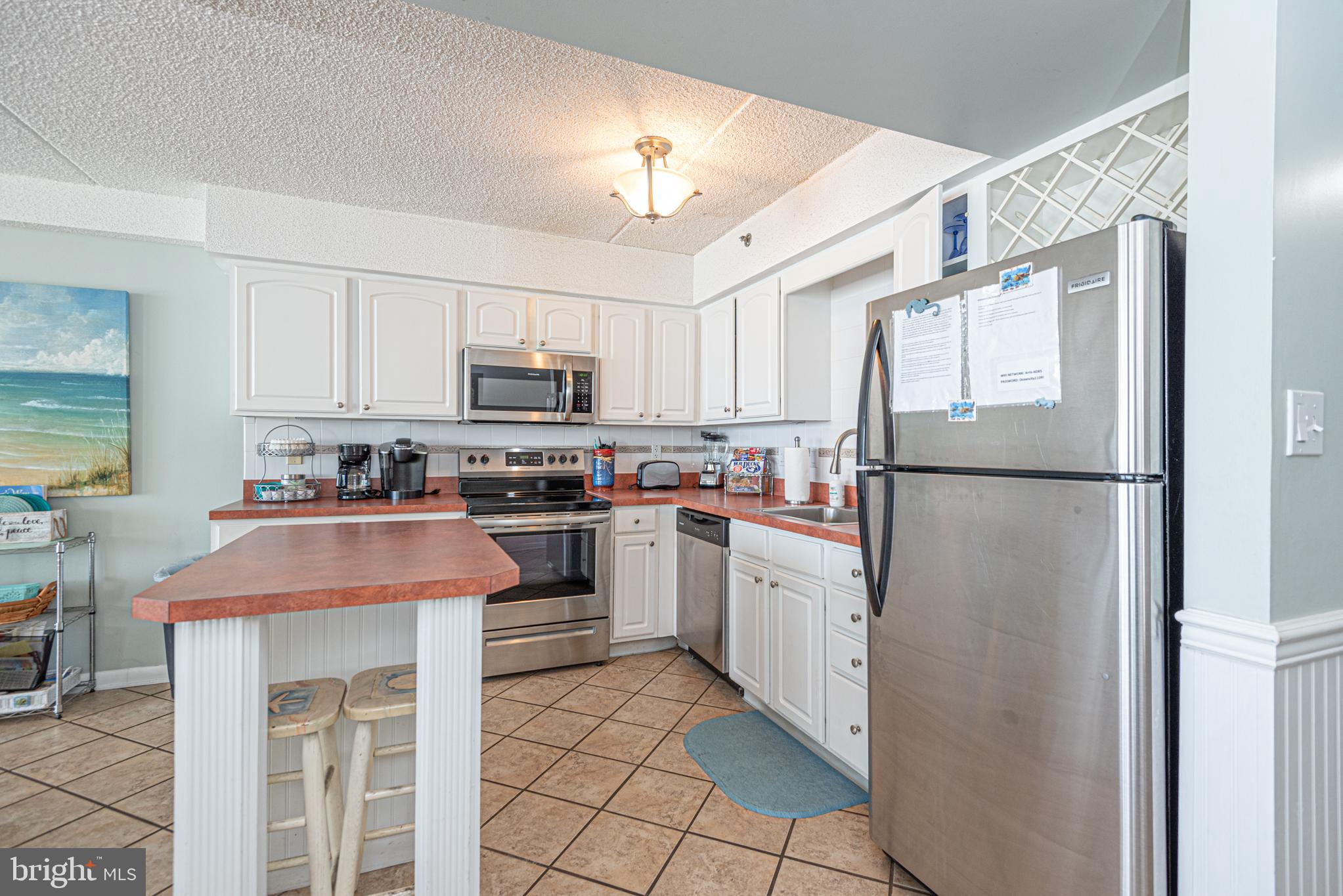 11700 Coastal Highway, Unit 1109 Ocean City, MD 21842 - Photo 25 of 50 a kitchen with cabinets stainless steel appliances and a window