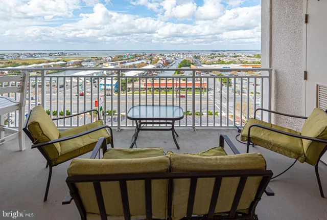 a view of a chairs and table on the balcony