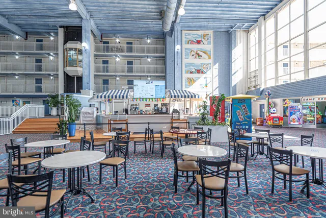 a roof deck with table and chairs