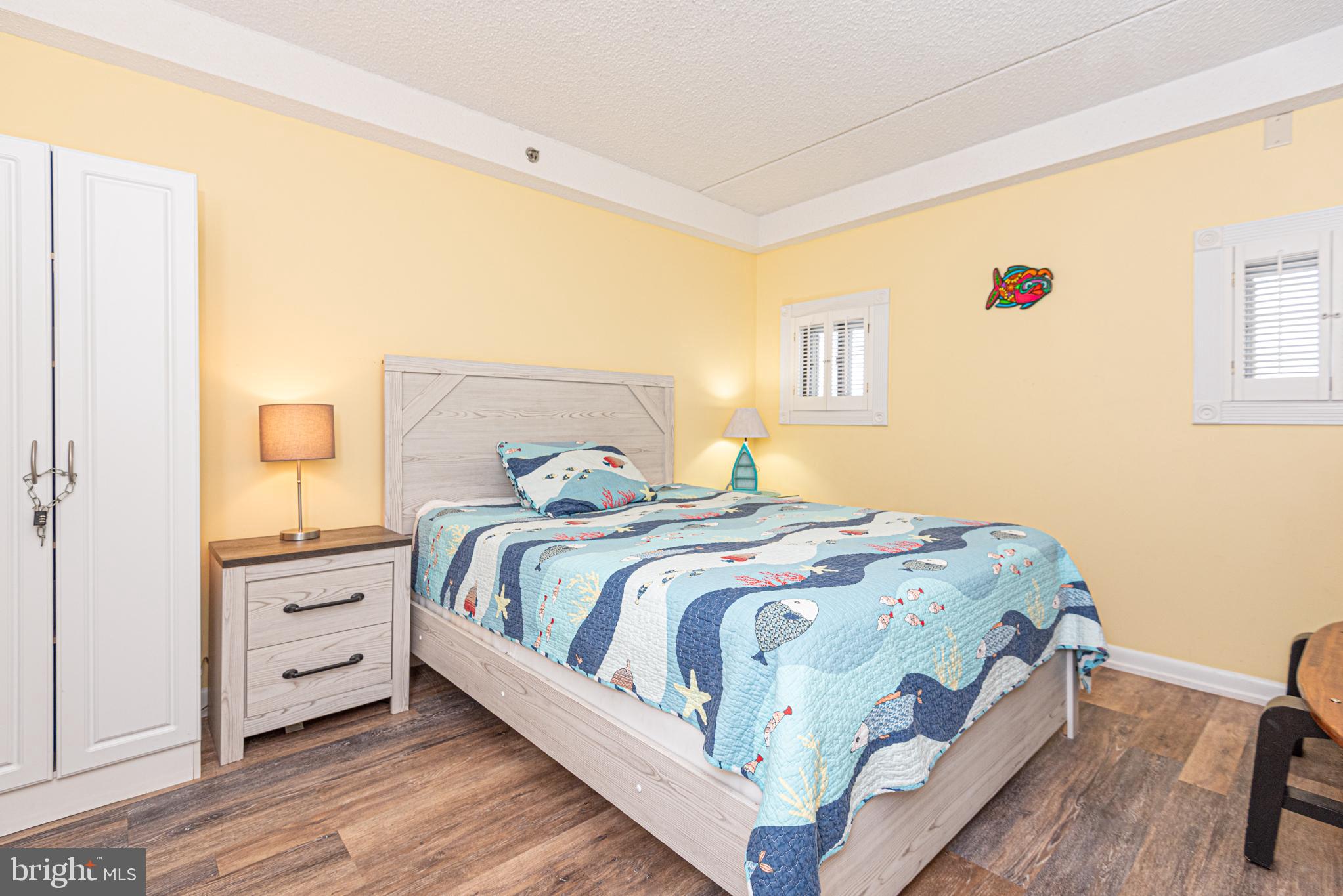 11700 Coastal Highway, Unit 1109 Ocean City, MD 21842 - Photo 7 of 50 a bedroom with a bed and a window