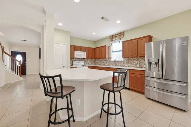 a kitchen with stainless steel appliances granite countertop a sink and cabinets