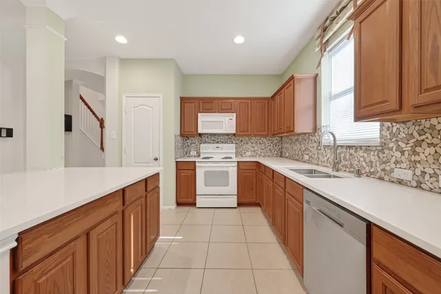 a kitchen with a sink stove and cabinets