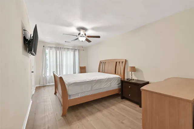 a bedroom with a large bed and a flat screen tv