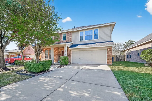 a front view of a house with a yard and a garage
