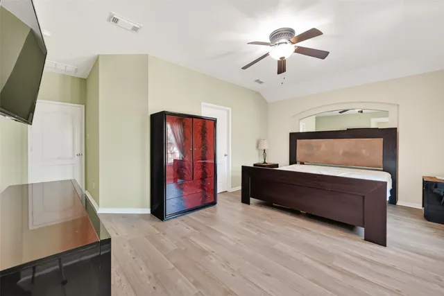 a bathroom with a tub a sink and mirror