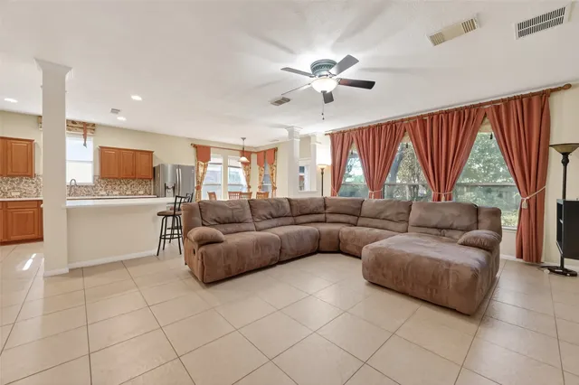 a living room with a bed furniture and a flat screen tv