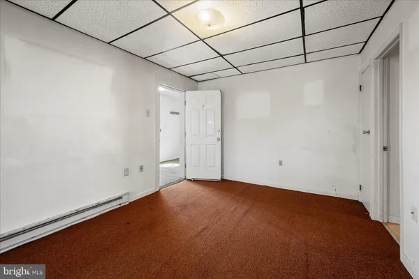 a view of a hallway with wooden floor and windows