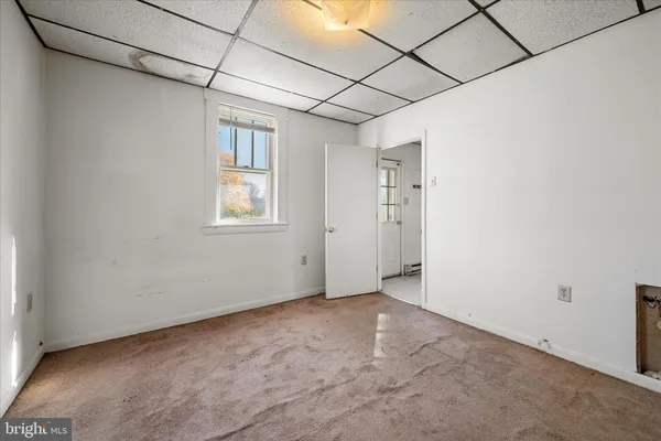 a view of empty room with a fireplace