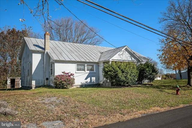 a backyard of a house with large trees