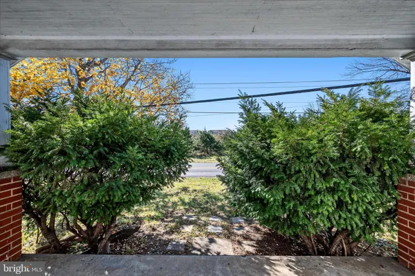 a view of a hallway with wooden floor and closet
