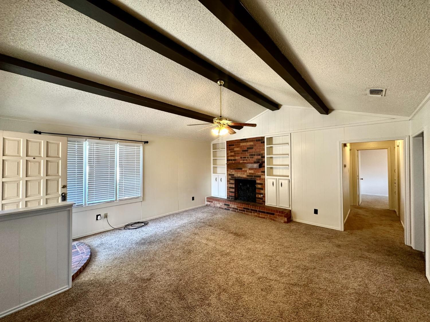 7805 Memphis Avenue, Unit B Lubbock, TX 79423 - Photo 2 of 13 an empty room with windows