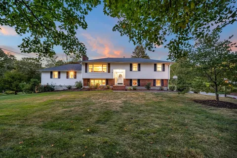 a front view of a house with a garden