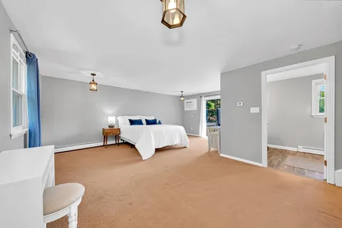 a bedroom with a bed and window