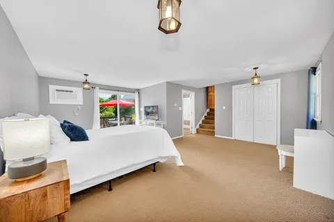 a bedroom with furniture and a window