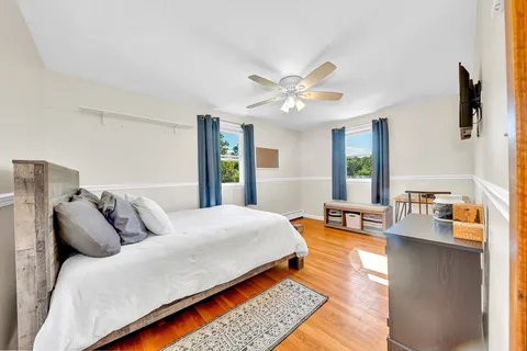 a bedroom with a bed a couch and a window